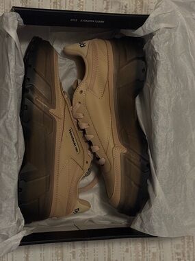 The Reebok Club C x Cardi B (Sahara) Monochromatic sandy tan leather and black.